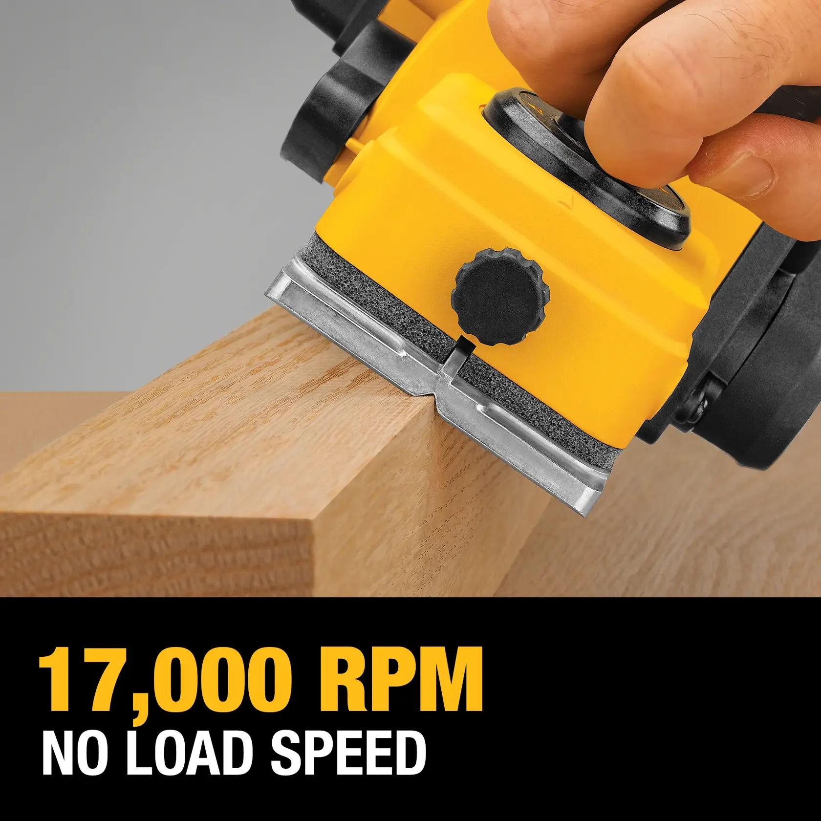 Close-up of a yellow DEWALT electric wood planer in use on a wooden plank, with text displaying '17,000 RPM NO LOAD SPEED' in bold yellow and white lettering.