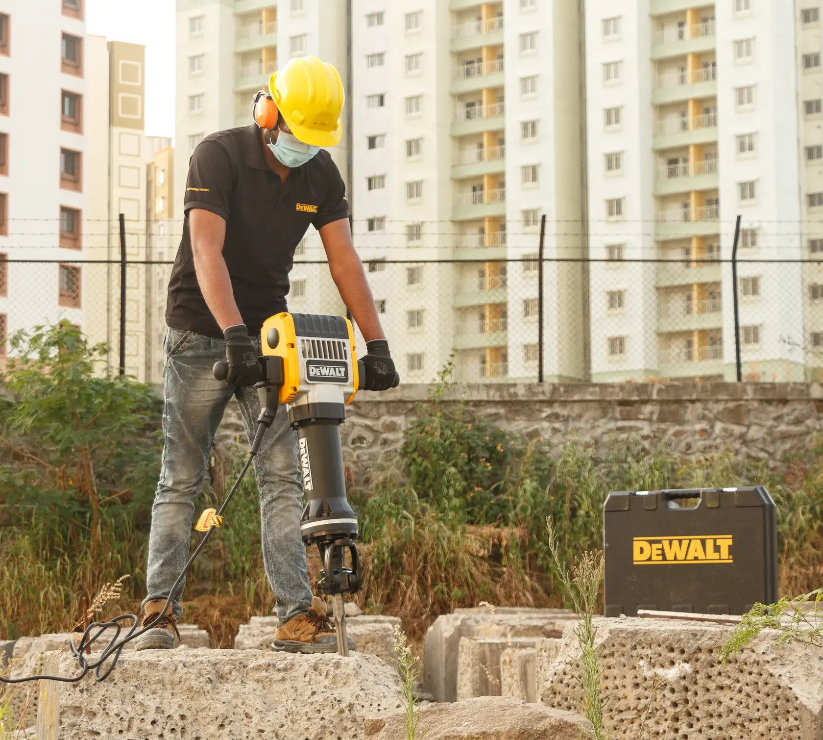 DEWALT jackhammer in use outdoors, SKUs D25981K-LX, D25981K, D25981K-QS. Case shown. Photography product category.
