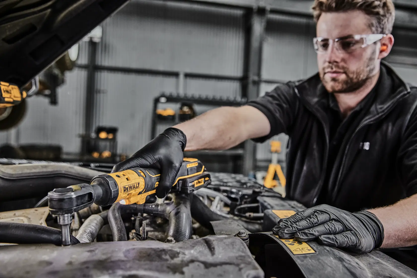 Photo of mechanic using DEWALT DCF512N-XJ, DCF512N ratchet tool on car engine in workshop.